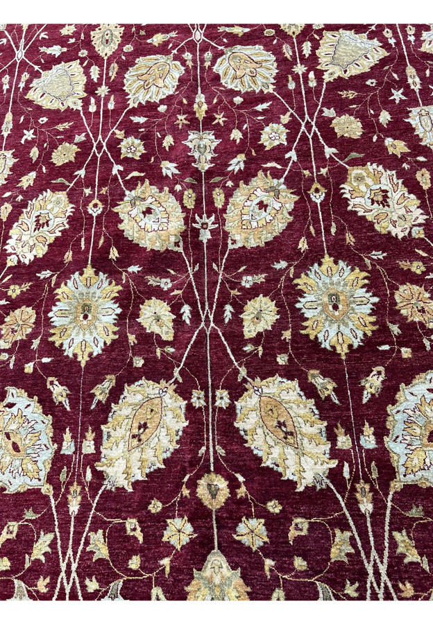 Midfield detail with floral palmettes and vine motifs on a burgundy Chobi Peshawar rug.