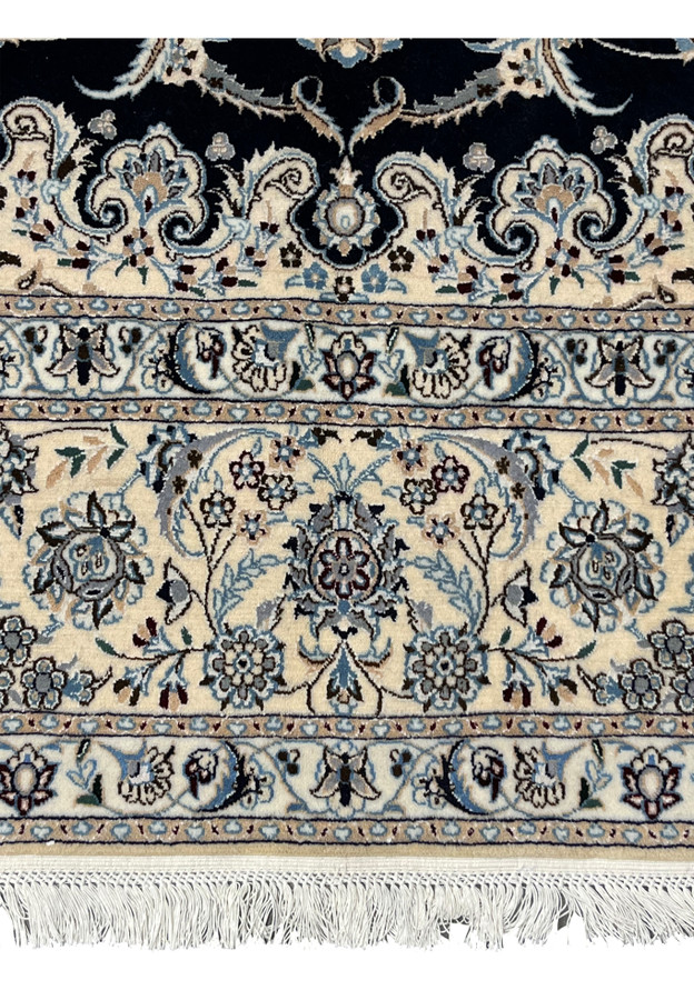 Lower border closeup of Persian Nain 6 LA silk rug with layered floral bands, ivory ground, and precise Habibian workshop detailing