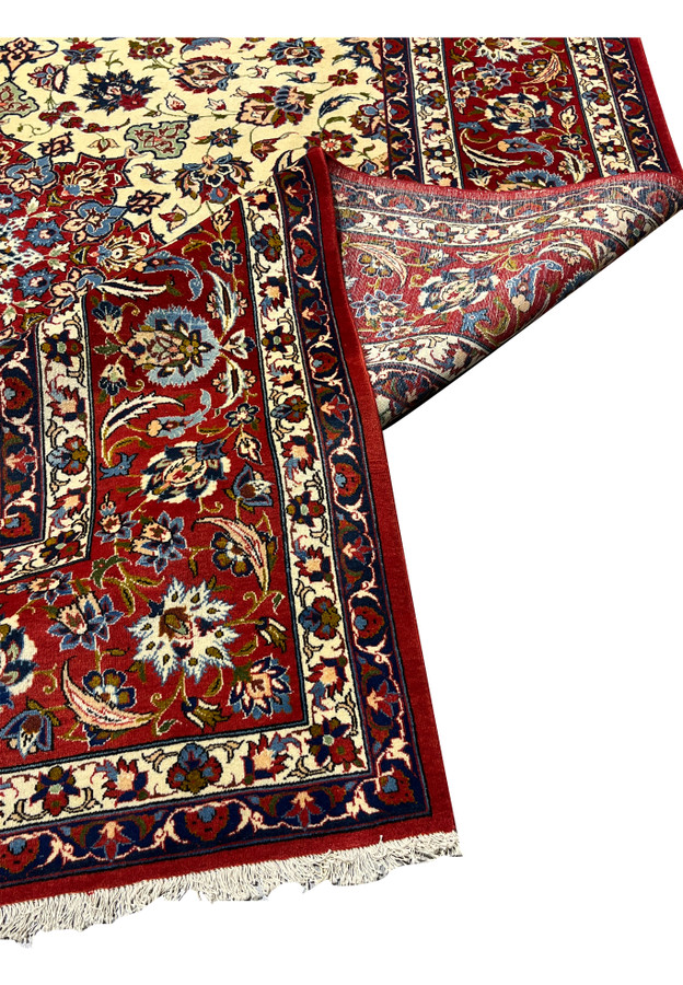 Folded corner view of a Persian Isfahan rug revealing clear pattern continuity, refined border work, and excellent material quality