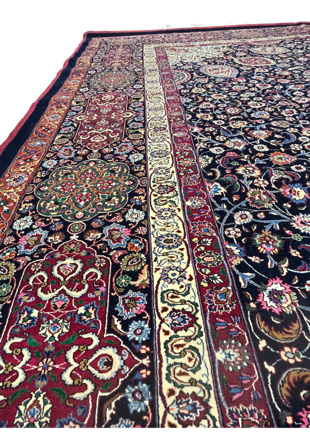 Side border view of Persian Mashad rug featuring complex floral motifs, crisp outlines, silk accents, and elegant color transitions along the edge.