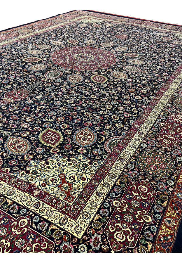 Angled perspective of Persian Mashad rug revealing pile depth, silk sheen, structured borders, and overall scale of this signed Sheshkalani masterpiece.