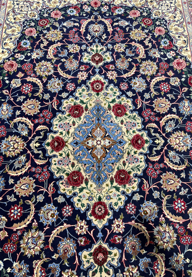 Full medallion view of a Persian Isfahan wool and silk rug with layered floral geometry, silk outlining, and crisp high knot density definition