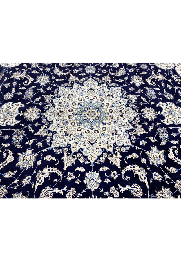 Close-up of the medallion in a Persian Nain 9 La oversize rug showing fine wool and silk details, crisp outlines, and balanced colors
