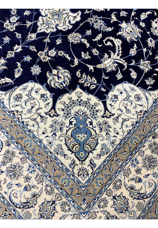 Inner border close-up of a Persian Nain 9 La oversize rug with beige ground, scrolling vines, light blue accents, and sharp detailing