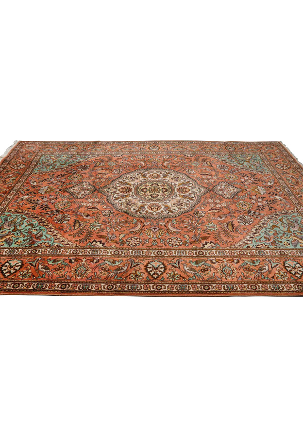 Laid-down view of a signed Persian Tabriz Paradies rug highlighting balanced proportions, warm terracotta tones, and detailed floral layout