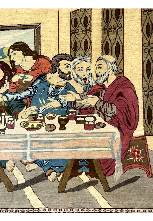 Side figure detail of signed Persian Qum silk Last Supper rug showing expressive faces, layered robes, and high-definition silk weaving