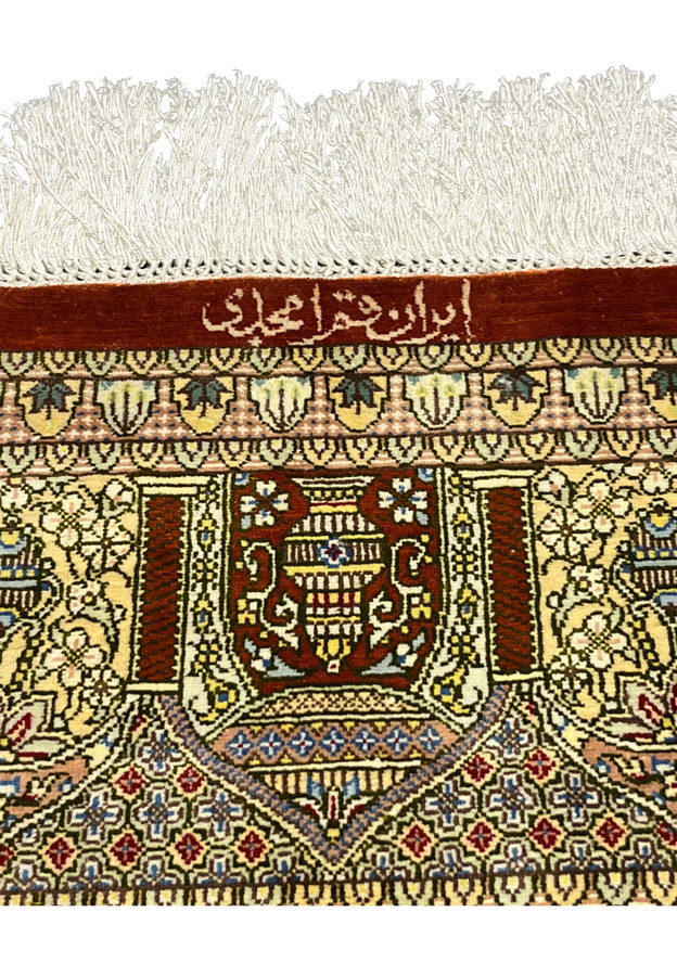 Amjadi signature close-up woven in silk on a Persian Qum square rug, confirming workshop authenticity and refined craftsmanship