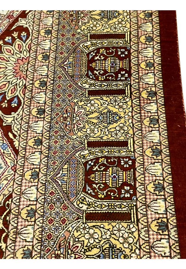 Zoomed border detail of signed Amjadi Persian Qum silk rug highlighting architectural motifs, floral accents, and precision silk knotting