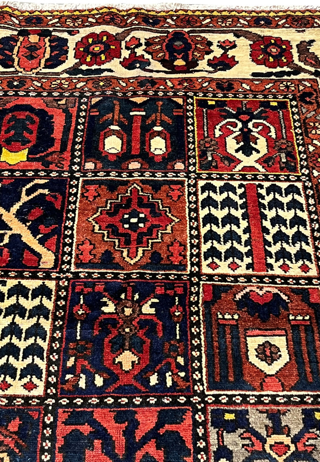 Pictorial square boxes in a Persian Bakhtiar rug showing trees, floral symbols, and geometric forms