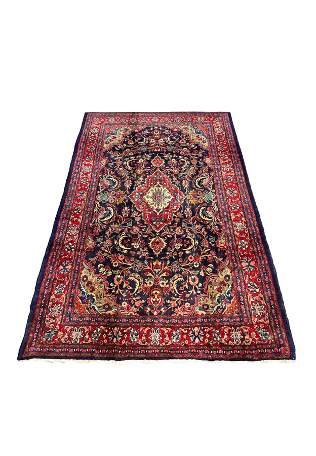 Persian Mahal wool rug top angle showing navy field large medallion red floral border and classic symmetrical design
