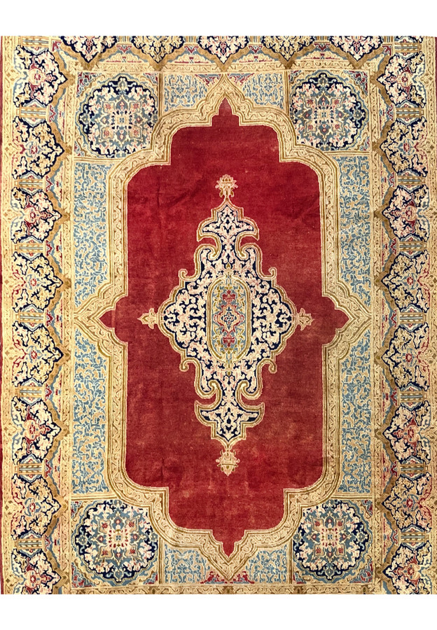 Antique Persian Kerman rug midfield close view brick red field ivory floral medallion navy vines hand knotted wool distressed patina
