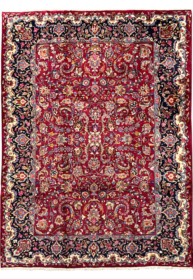 Full view of 8'1 x 11'1 Persian Mashad rug signed Makhmal Baf with brick red field, navy floral borders, and intricate medallion design