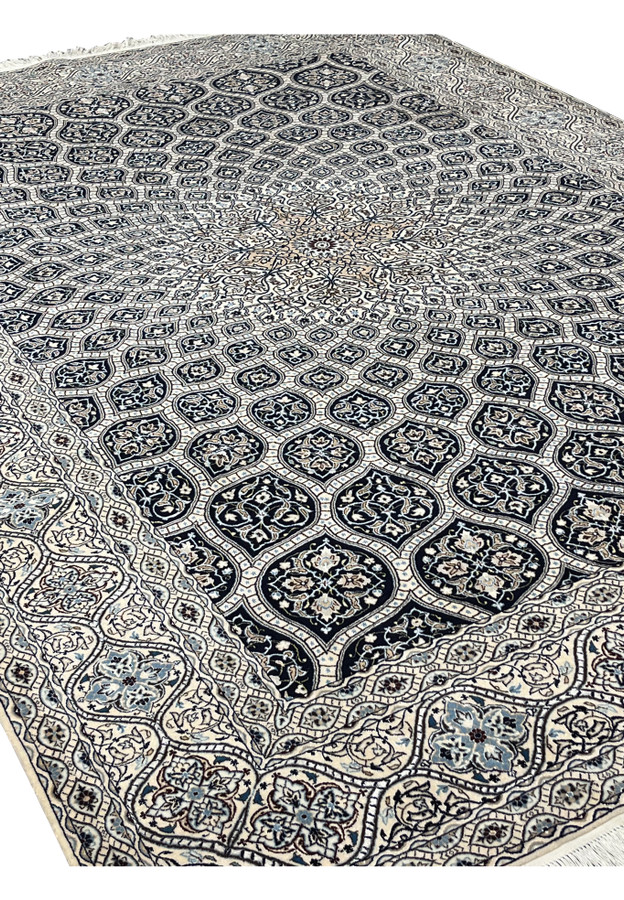 Top angled view of Persian Nain Habibian 6 LA Gombadi rug ivory navy intricate floral dome design.