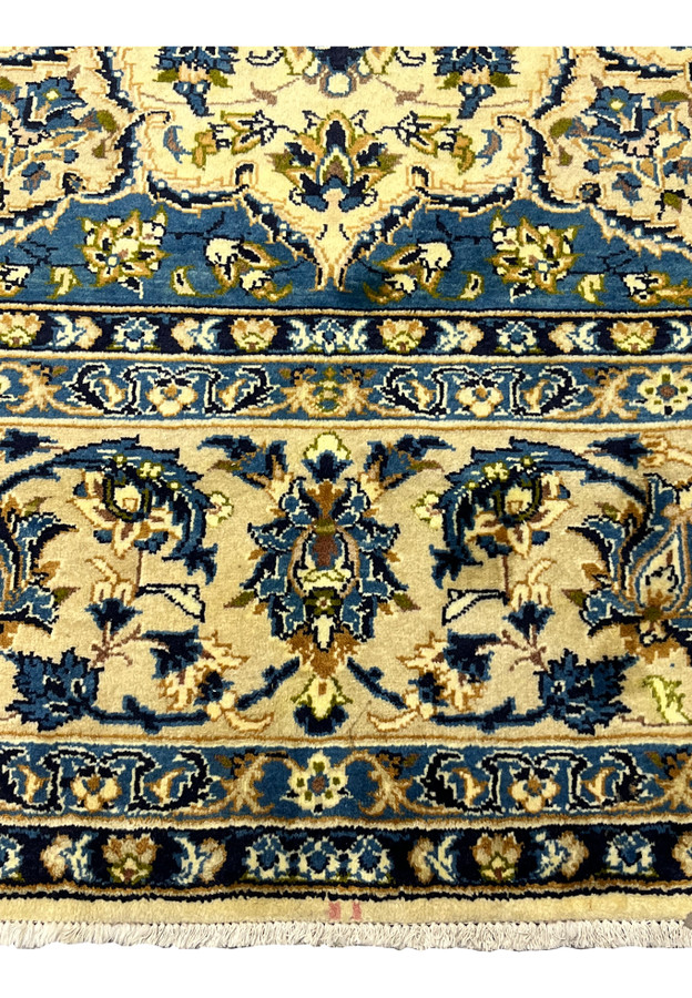 Lower navy border of 10'2 x 14'3 Persian Kashan rug with scrolling floral vines ivory guard stripes and dense weave