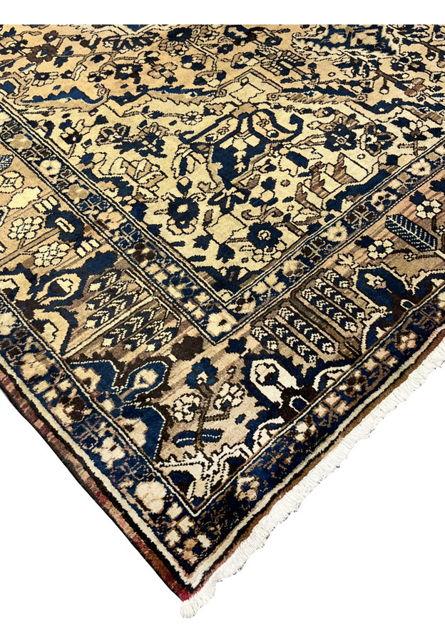 Edge detail of vintage Heriz rug in navy and ivory showing strong wool pile and traditional hand knotted craftsmanship