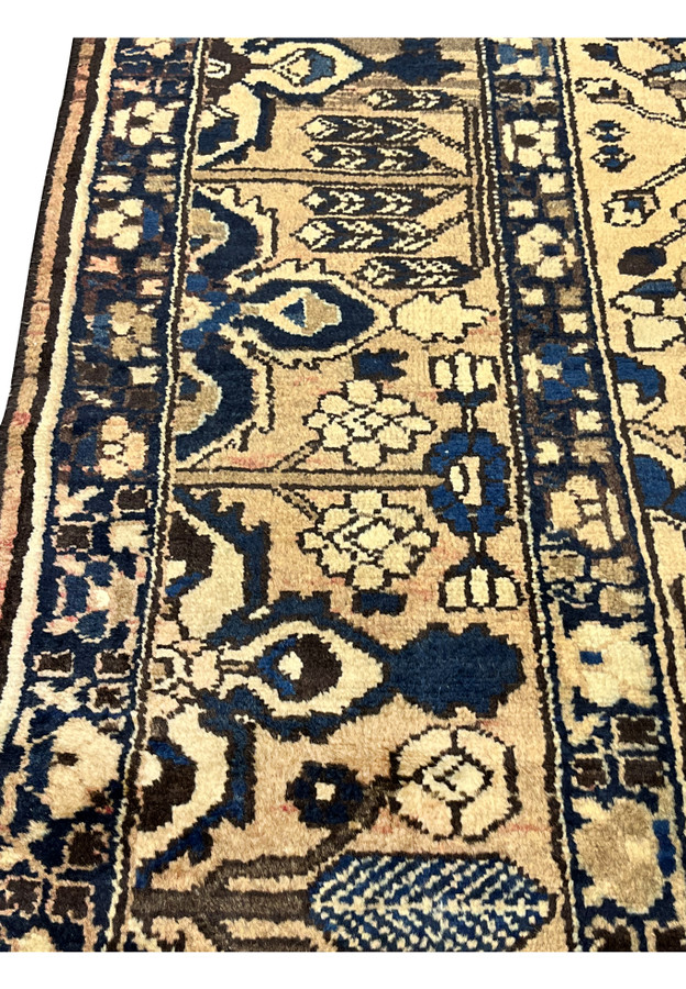 Closeup of 11x13'3 vintage Persian Heriz rug border in muted navy, ivory and taupe showing detailed geometric motifs and hand knotted wool.