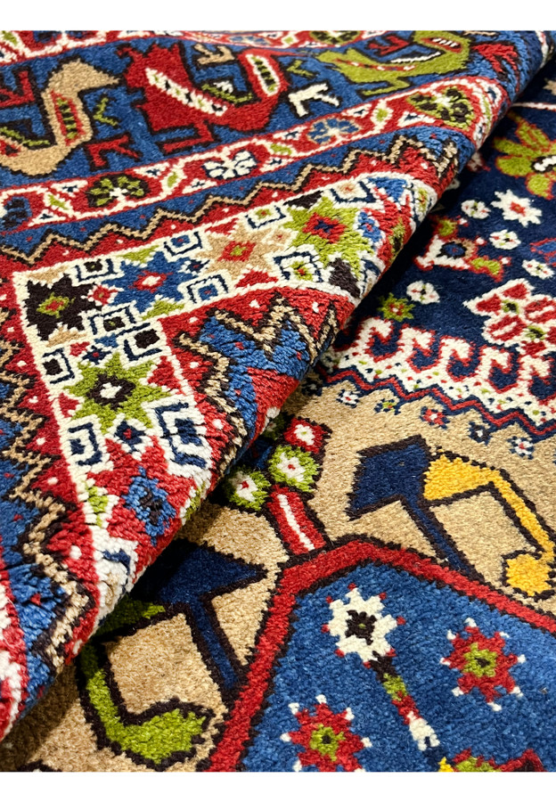 Persian Yalameh navy and red wool rug rolled corner detail showing pile thickness and tight tribal weave