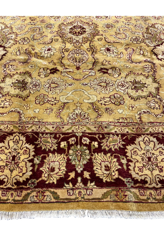 Lower border detail of 9x12 gold Agra rug showing burgundy floral border and ivory guard stripes.