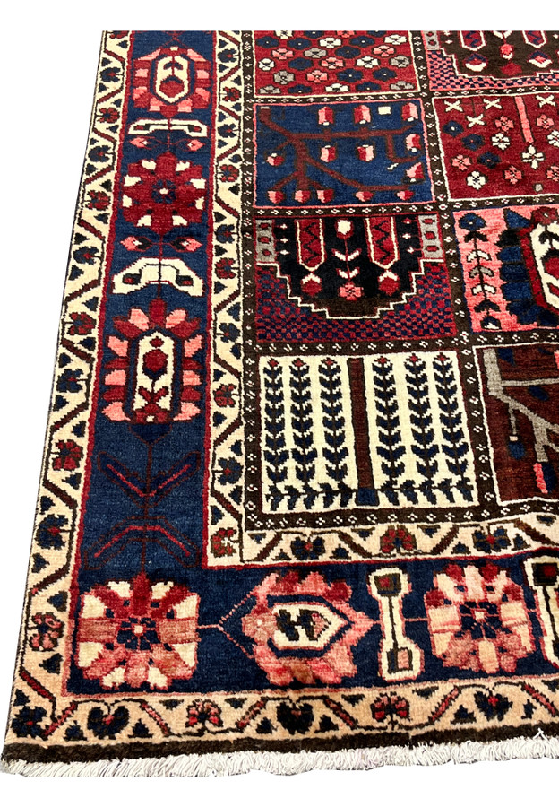 Navy main border with rosette and vine motifs on 7x10 Persian Bakhtiari panel rug