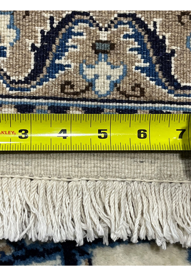 Backside of 8x11 Persian Nain 9La rug with ruler showing fine knot density and cotton foundation