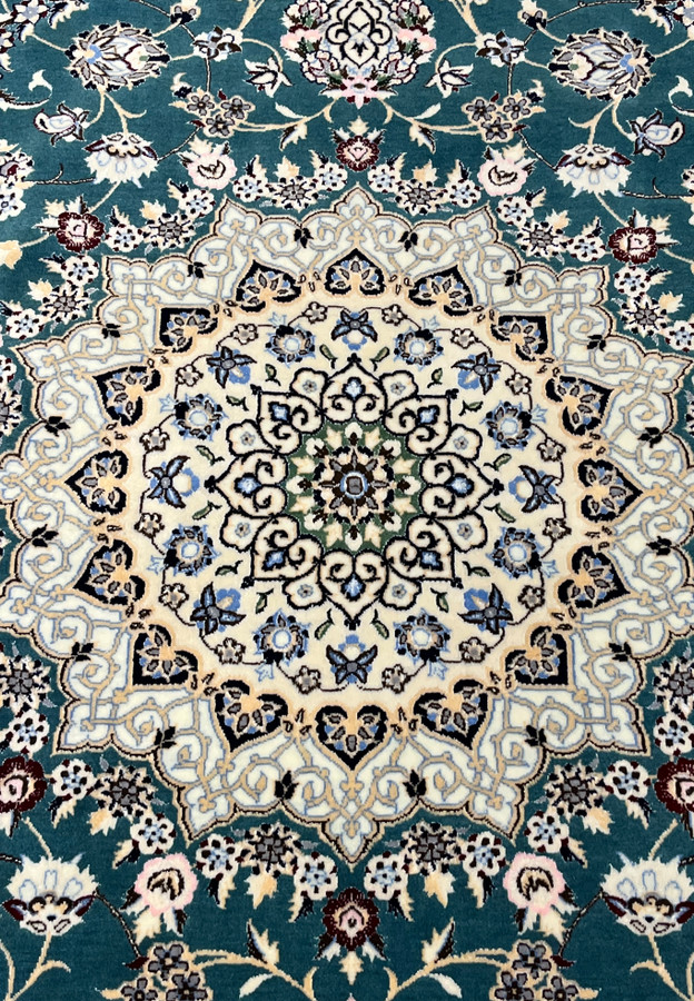 Close-up of ivory star medallion on 7x10 Persian Nain 6La Habibian teal and ivory rug