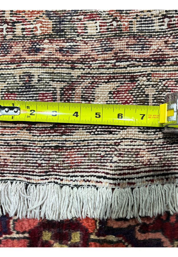 Backside of antique 3'7x5 Persian Bakhtiari rug with ruler confirming 152x110cm dimensions