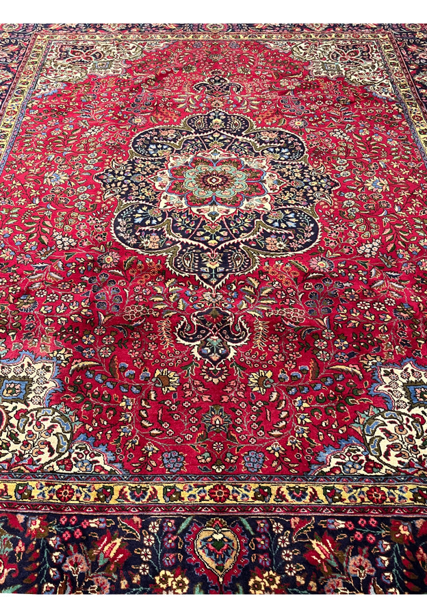 Field view of 10x13 Persian Tabriz rug, allover floral sprays on deep red with pendant finial