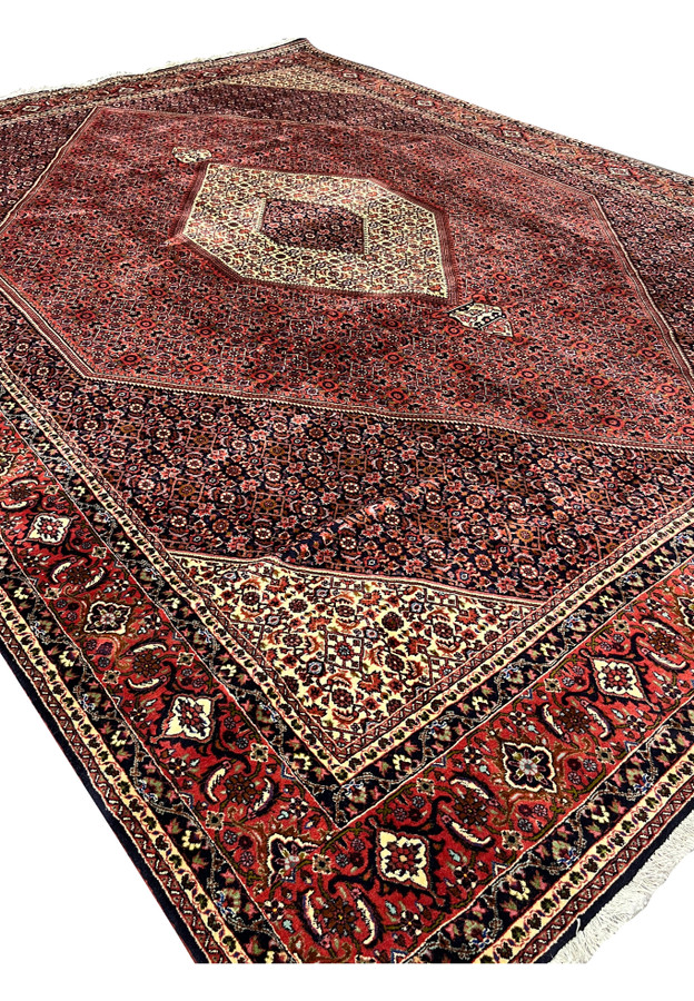 Angled view of authentic Persian Bijar iron rug 10x13 with medallion and Herati field