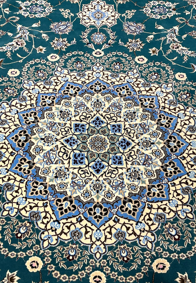 Ivory eight-point star medallion with blue palmettes at the heart of this authentic Persian Nain rug