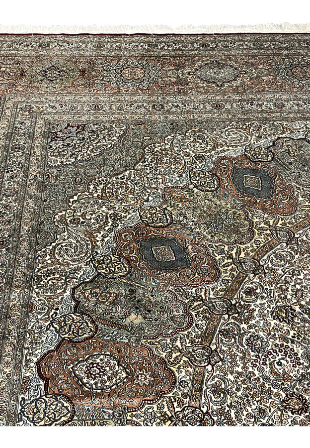 Inner guard border with dense floral scroll separating ivory field from copper main border