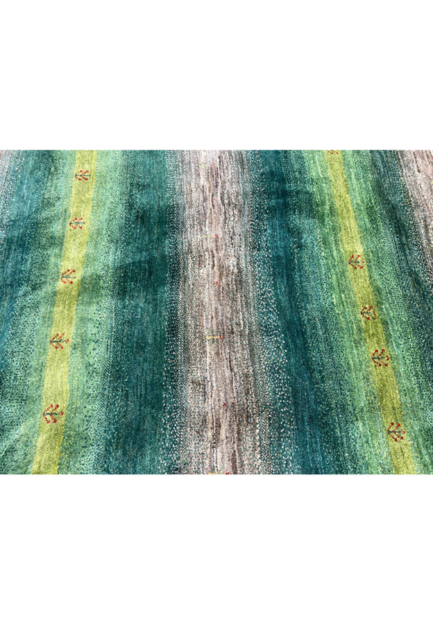 Vibrant emerald lime and sage green color close-up of authentic hand-knotted Indian Gabbeh wool rug