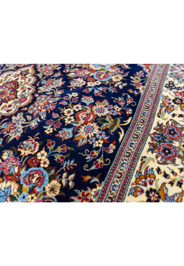 Midnight navy field of Persian Qum kork rug densely woven with peony rose and daisy floral bouquets