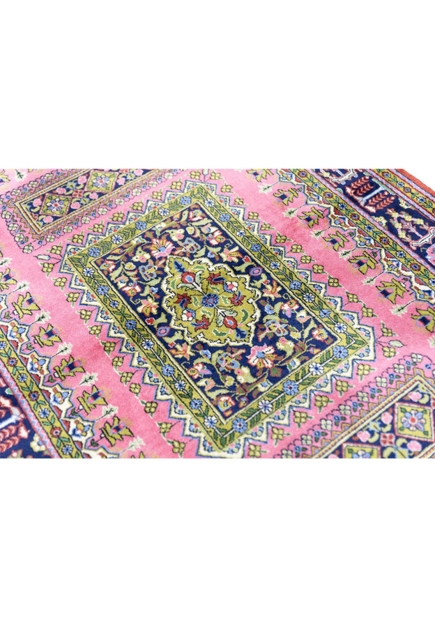 Central cartouche close-up of vintage Persian Qum rug with lime green medallion on midnight navy ground