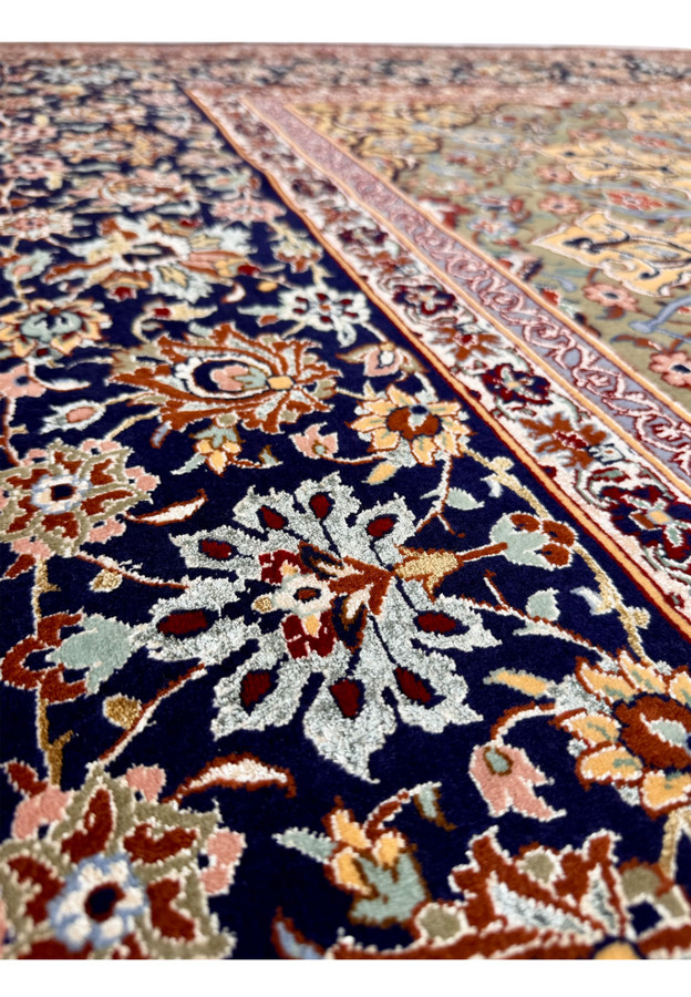 Border closeup of authentic Persian Isfahan rug with palmette and vine repeat on midnight navy ground
