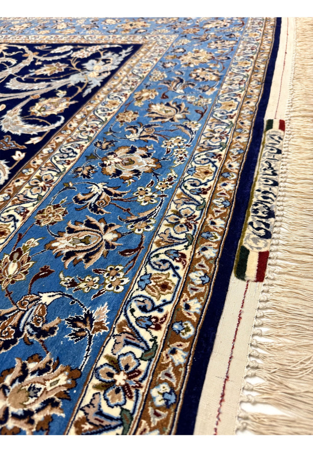 Signature border closeup of Zolfaghari Isfahan rug showing master cartouche and Iranian flag woven into apron