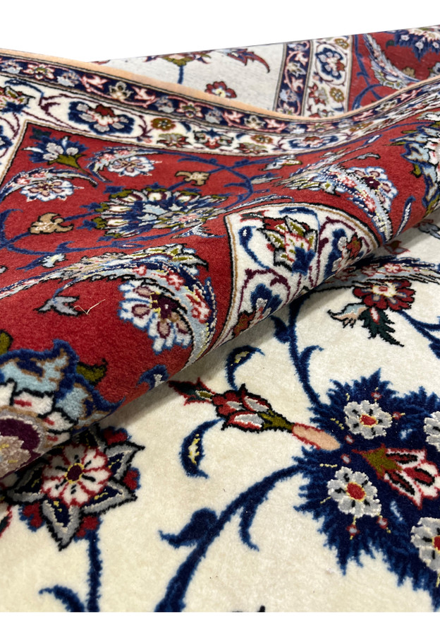 Rolled view of the Isfahan rug showing the supple drape of kork wool and silk pile on silk foundation