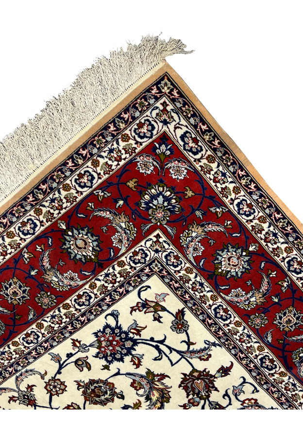 Edge detail of authentic handmade Isfahan rug showing tight selvage and precise border alignment