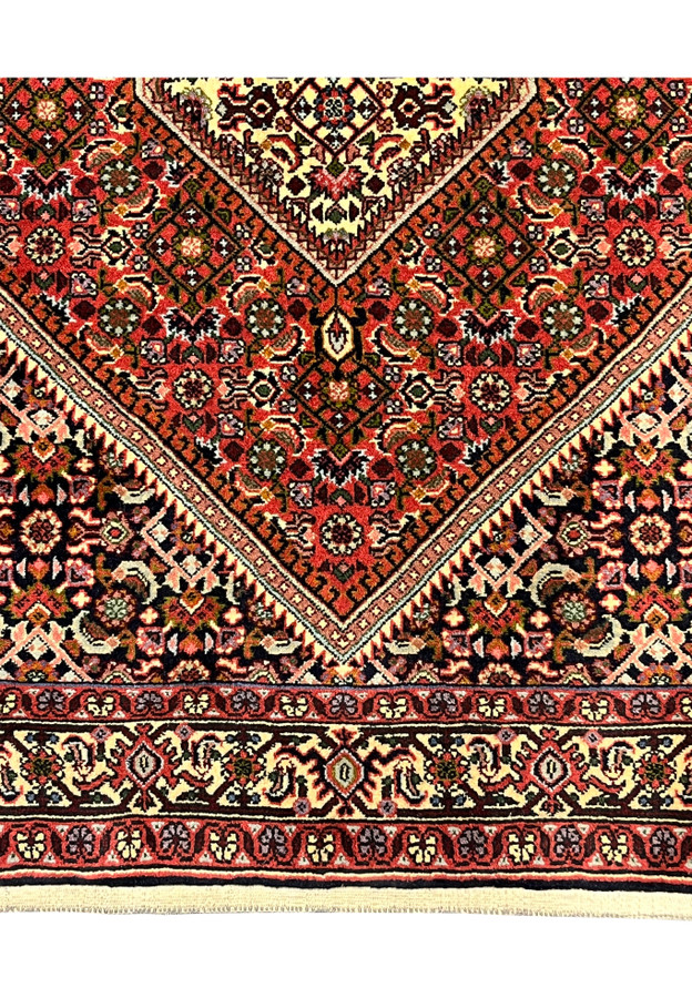 Lower border detail with turtle palmettes on cream ground above the natural cotton fringe