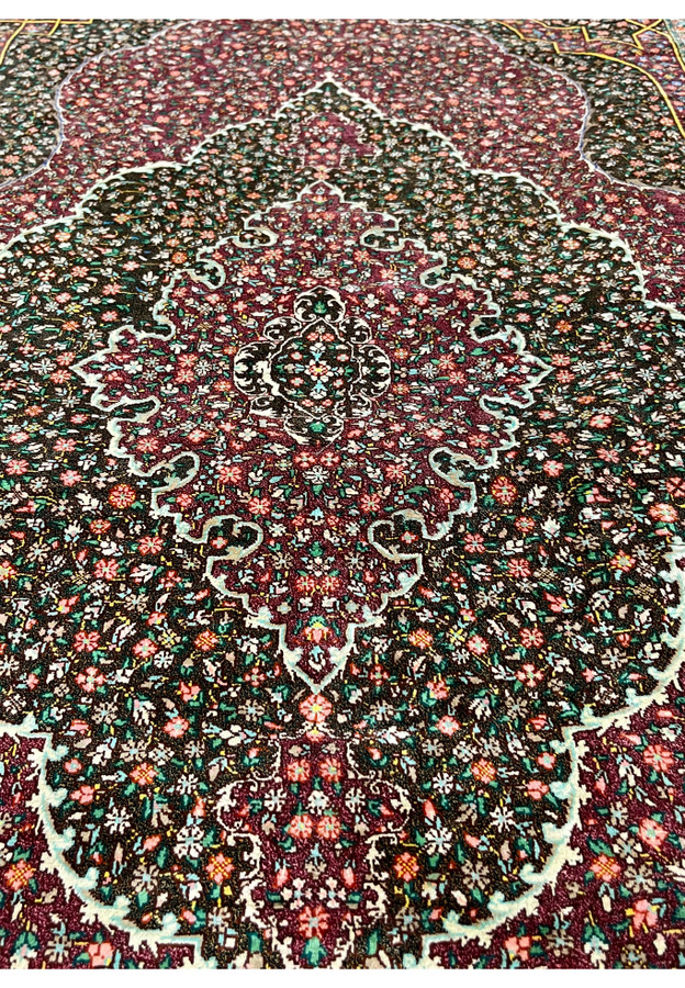 Midfield detail of the pure silk pile showing the painterly density of floral motifs