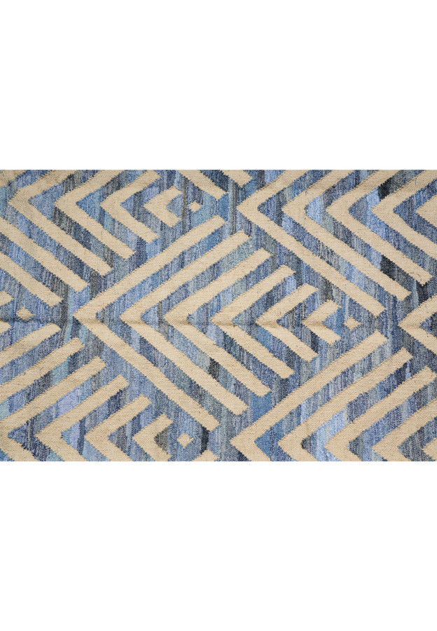 Pattern detail of nested chevrons and concentric diamonds in chambray, slate, and indigo blues against cream cotton