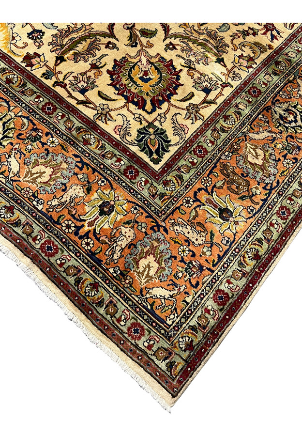 Border corner detail showing the sage green guard borders reciprocal floral cartouches and the precision of Tabriz drawing