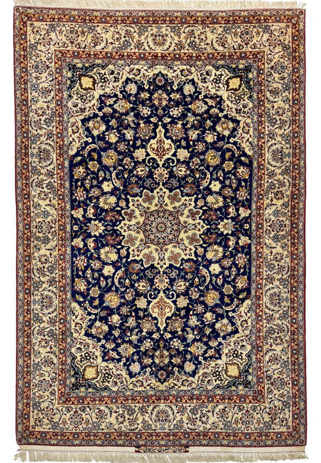 Signed Mir Jalali Persian Isfahan wool and silk rug with ivory star medallion on a royal navy field framed by an ivory main border