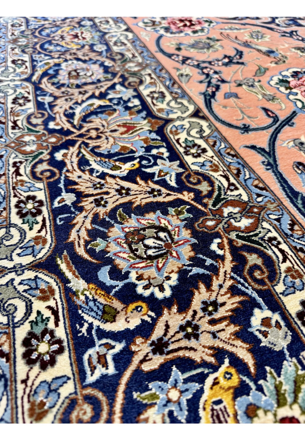 Inner border closeup showing the navy main border with rosette palmettes, scrolling acanthus, and small yellow songbirds woven into the vines