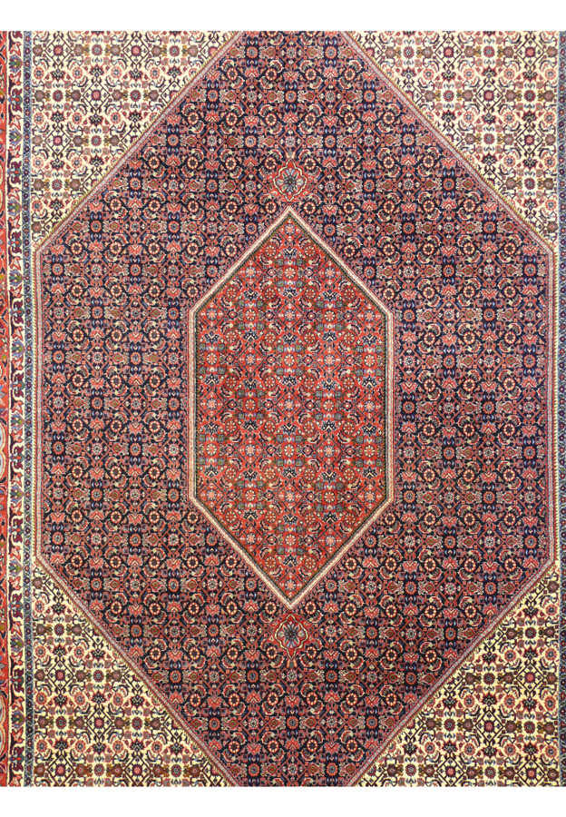 Close-up of central diamond medallion on Persian Bijar rug showing dense herati fish pattern in red and navy