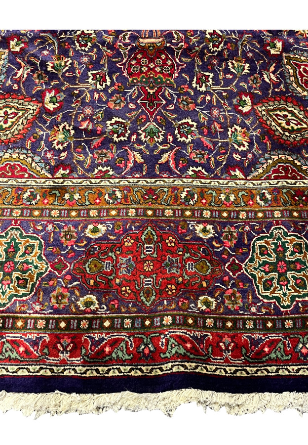 Lower border detail of Persian Tabriz rug showing mosque lamp pendant and floral cartouche main border