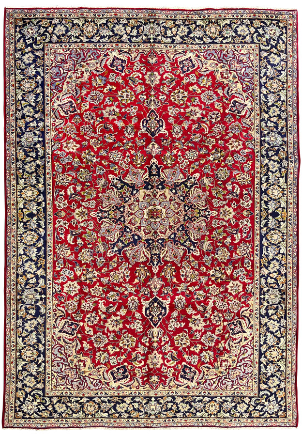 Full overhead view of Persian Isfahan rug with crimson field, navy lobed medallion, and Shah Abbas allover floral