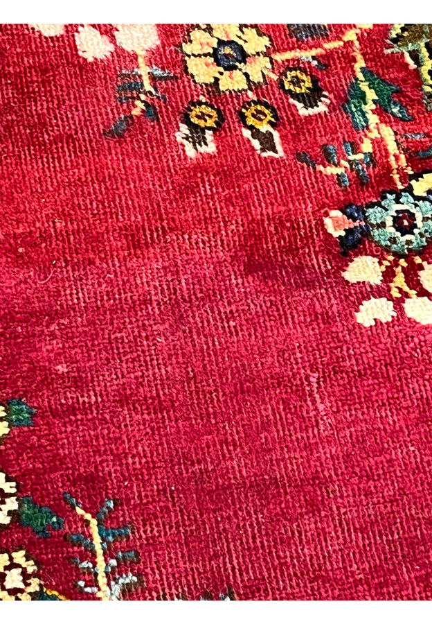 Closeup detail showing minor pile wear and worn spots on field of Persian Kerman rug, documented for transparent condition disclosure