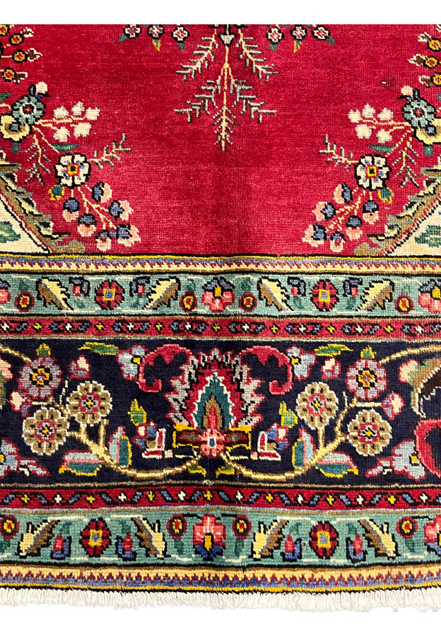Lower section of 9x13 Persian Kerman rug showing lower pendant cartouche, turquoise minor border, and palmette main border in detail