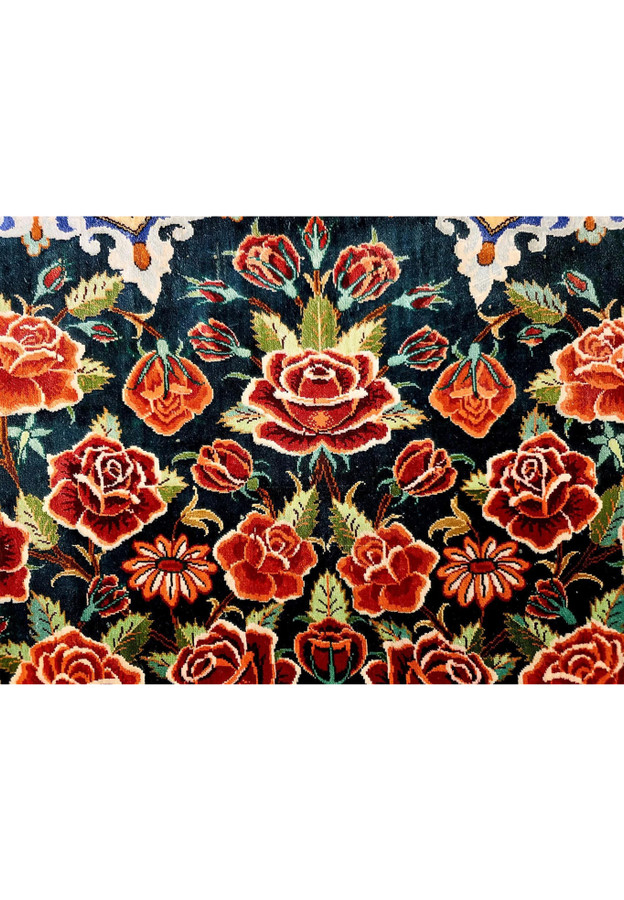 Close detail of full bloom red roses, coral roses, and daisies woven in pure silk on midnight ground of Mohseni Qum