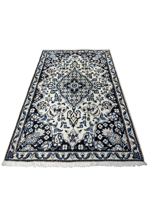 Authentic hand knotted Persian Nain rug photographed flat, ivory ground, dark navy spandrels, blue floral medallion at center